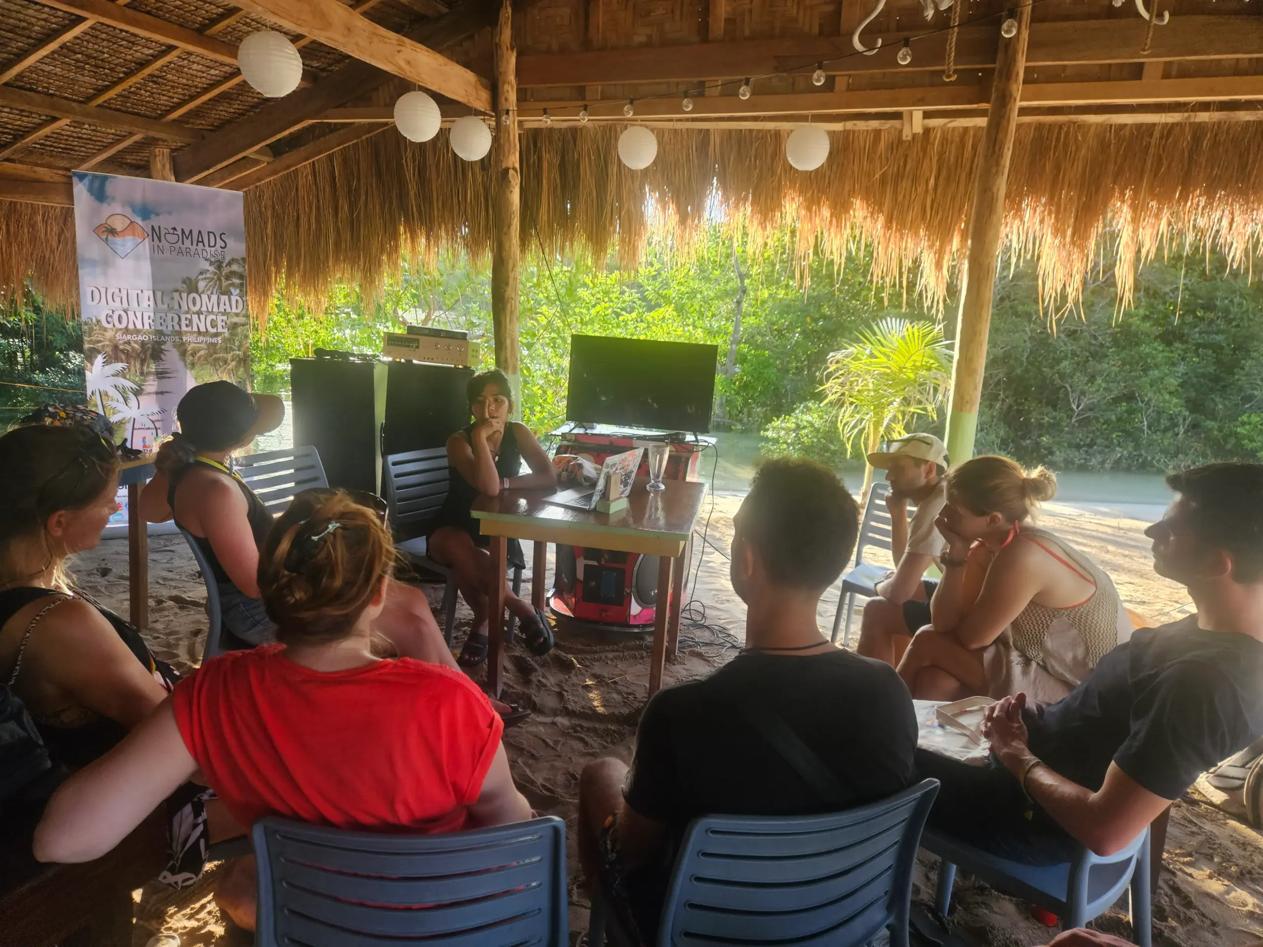 Outdoor workshop under thatched pavilion with lagoon view at Nomads in Paradise Siargao