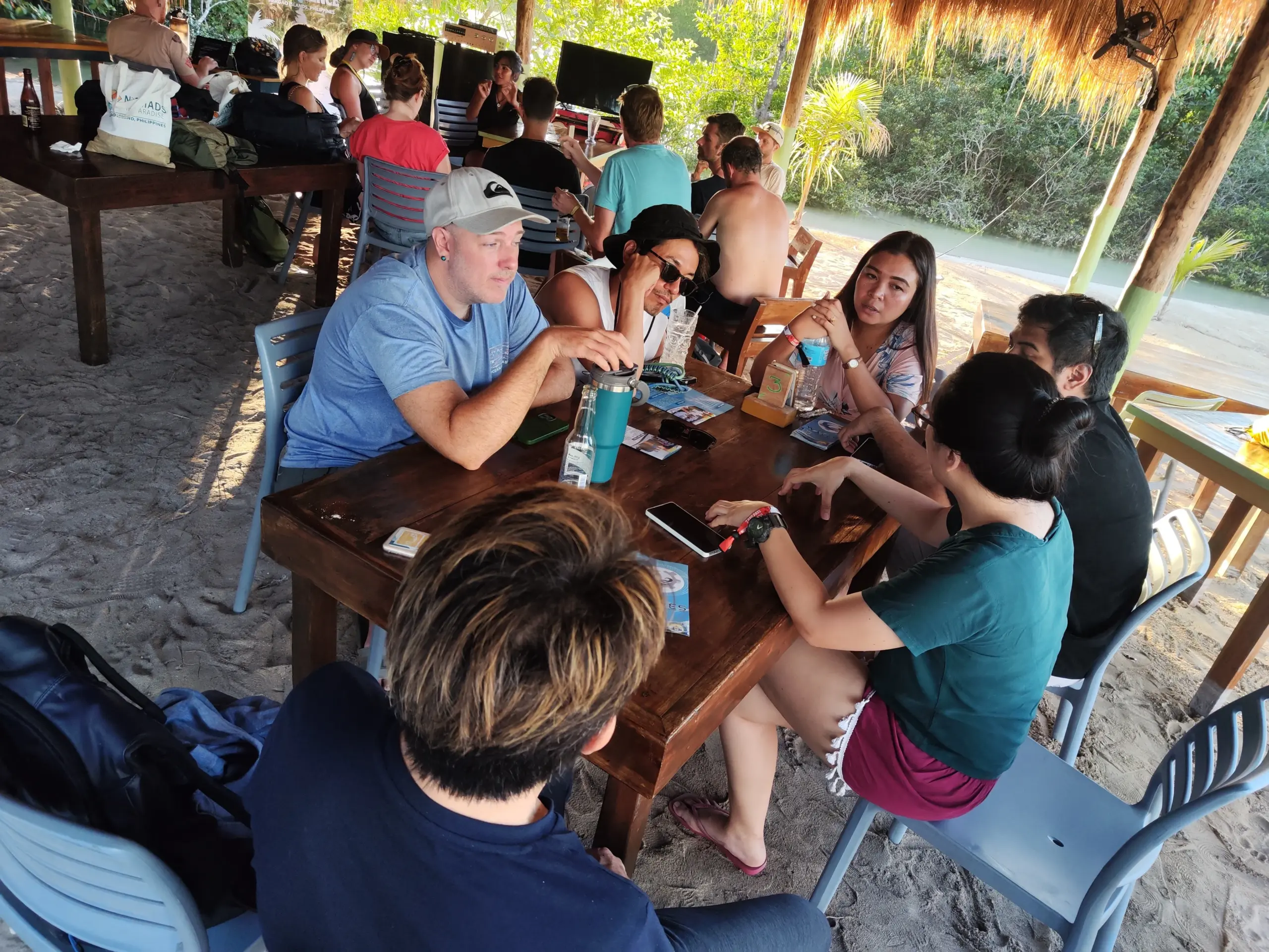 Attendees networking under thatched beach pavilion at Nomads in Paradise Siargao digital nomad festival