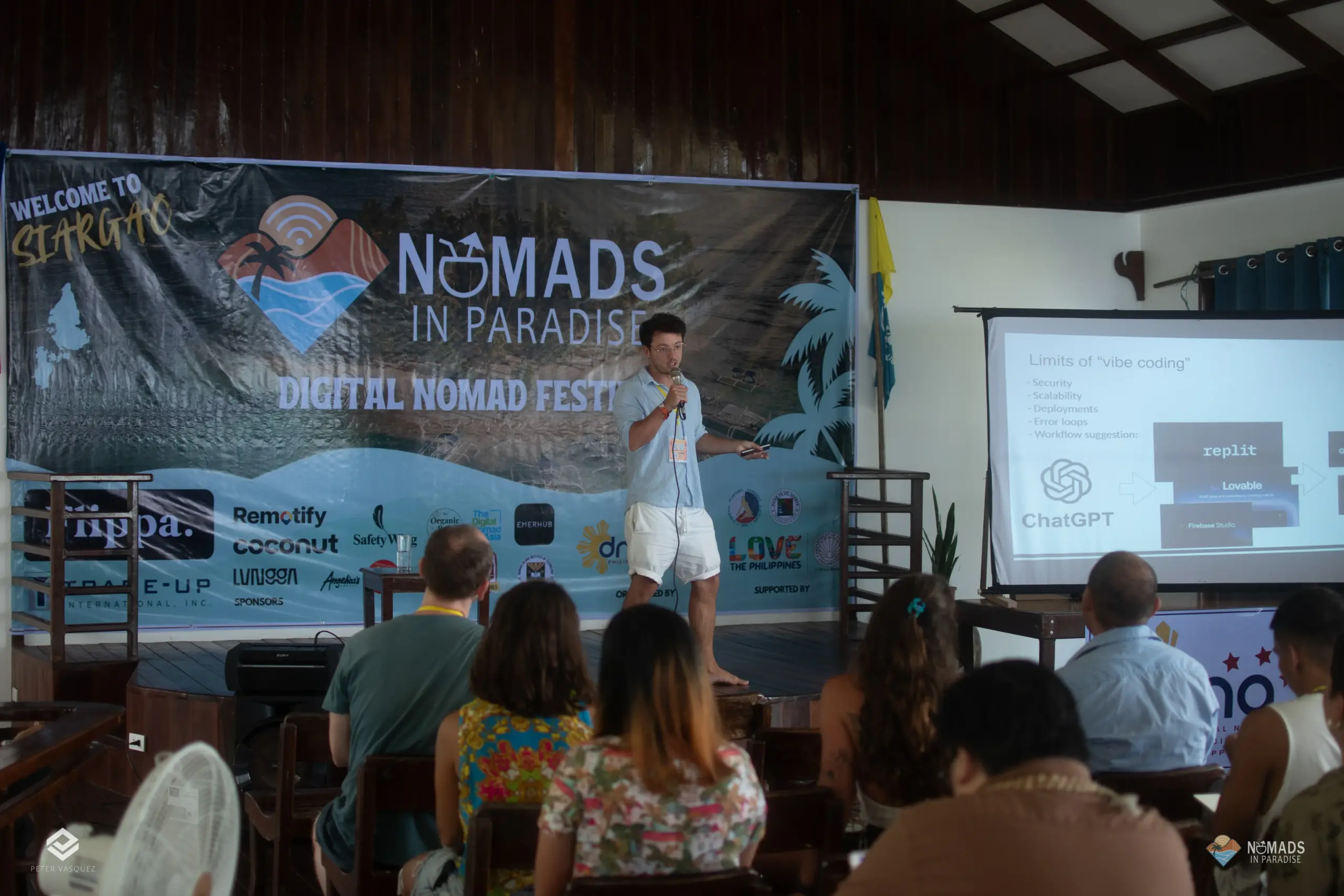 Barefoot speaker on wooden stage presenting at Nomads in Paradise digital nomad festival Siargao