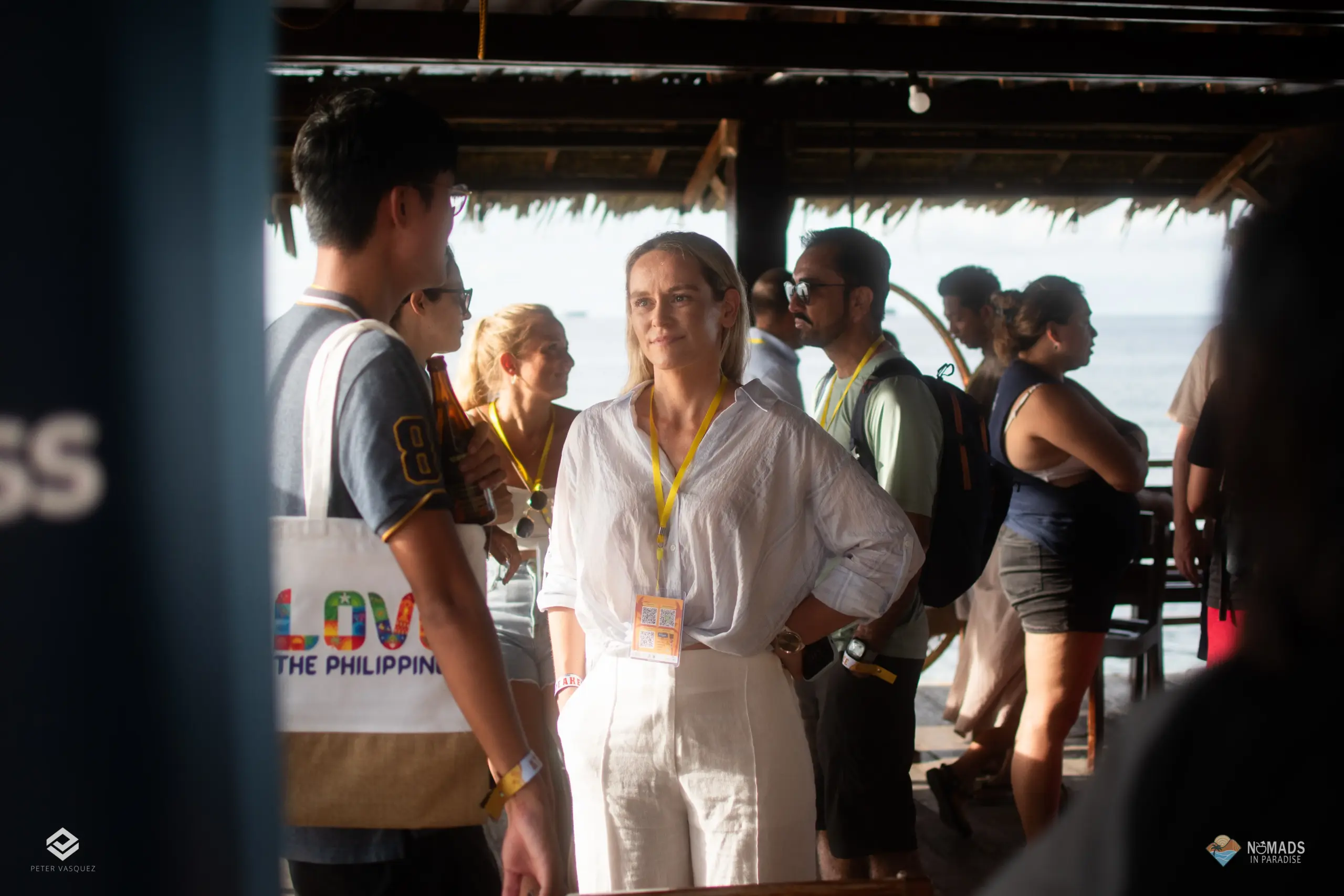 Attendee networking at seaside pavilion during Nomads in Paradise day one